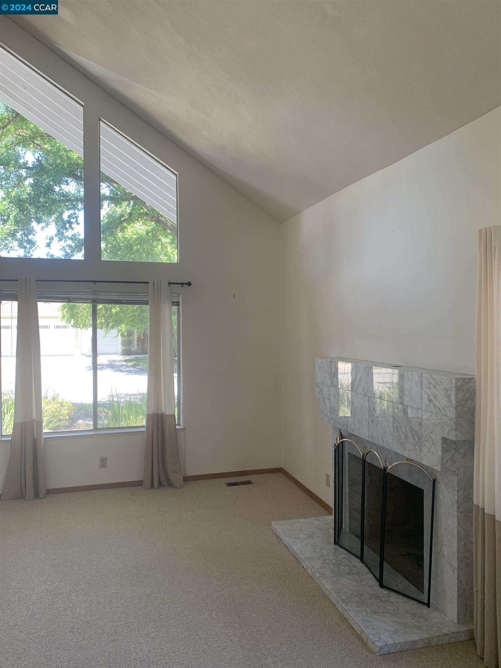9462 Thunderbird Place San Ramon, CA 94583 - Photo 9 of 17 an empty room with windows and fireplace