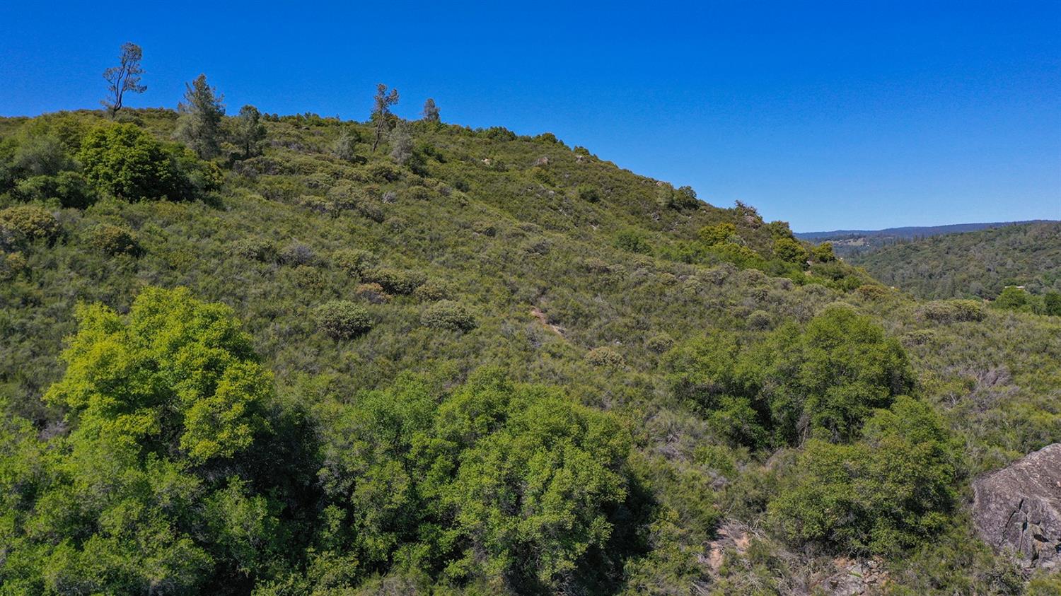 6412 Mt Aukum Road Somerset, CA 95684 - Photo 47 of 65 a view of a large building with a mountain in the background