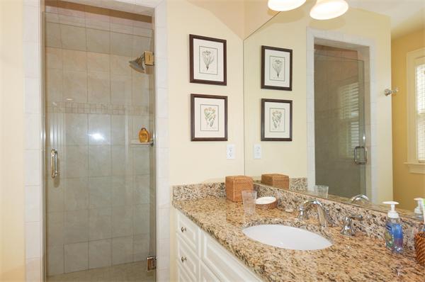46 Coburn Hill Road Concord, MA 01742 - Photo 20 of 27 a bathroom with a granite countertop shower sink and mirror