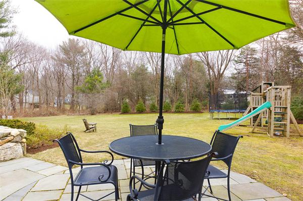 46 Coburn Hill Road Concord, MA 01742 - Photo 24 of 27 a view of a table and chairs under an umbrella