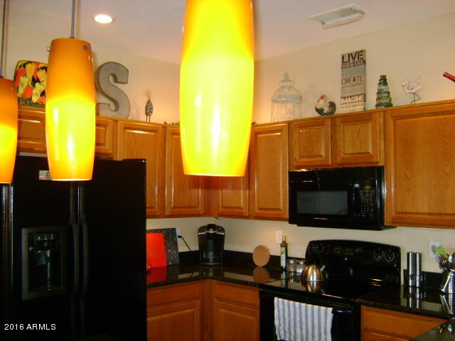 11174 West Berkeley Road Avondale, AZ 85392 - Photo 7 of 41 a kitchen with a sink and a stove top oven