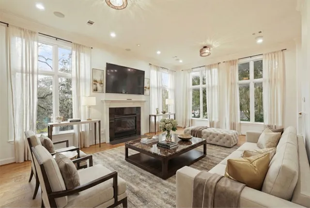 a living room with a flat screen tv a fireplace and a window