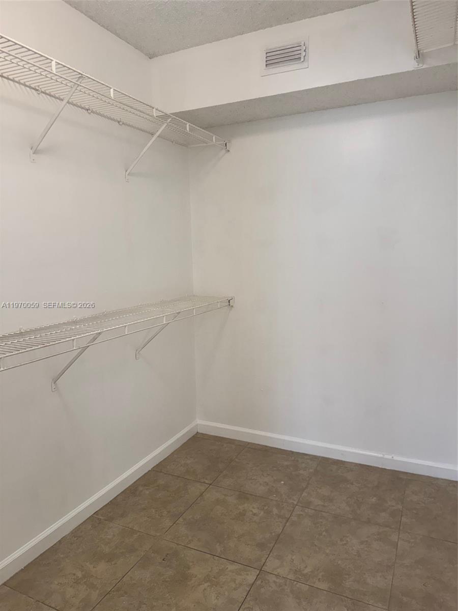 9001 Wiles Road, Unit 204 Coral Springs, FL 33067 - Photo 11 of 16 a view of a room with racks on the wall
