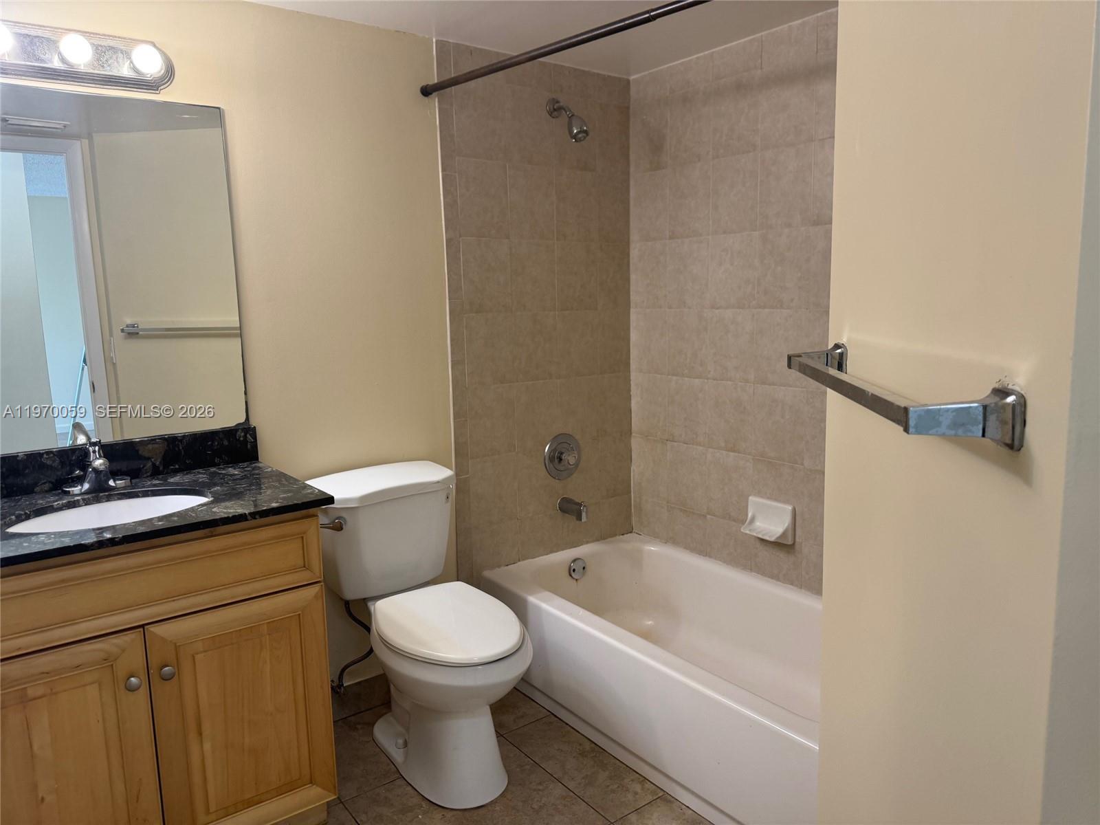 9001 Wiles Road, Unit 204 Coral Springs, FL 33067 - Photo 14 of 16 a bathroom with a sink a toilet and shower