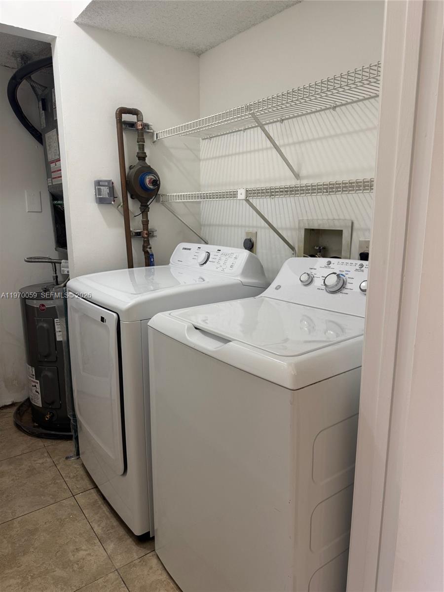 9001 Wiles Road, Unit 204 Coral Springs, FL 33067 - Photo 16 of 16 a utility room with dryer and washer