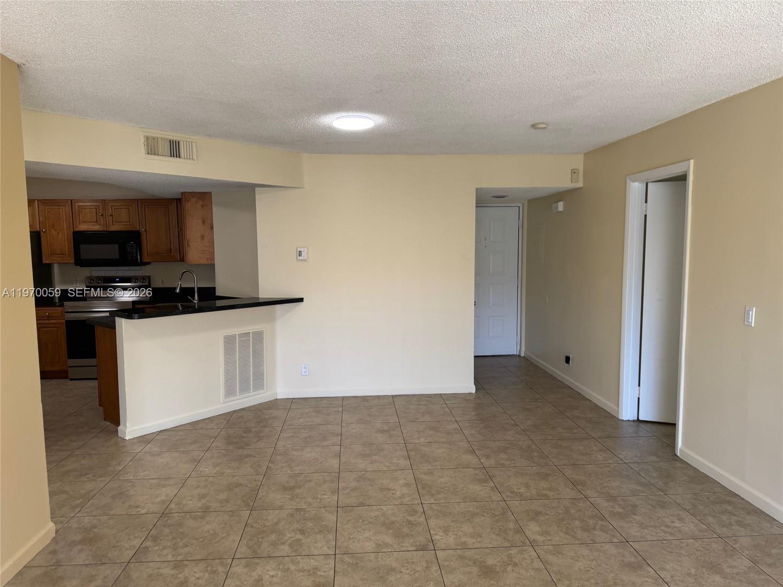 9001 Wiles Road, Unit 204 Coral Springs, FL 33067 - Photo 8 of 16 a view of kitchen with microwave and cabinets