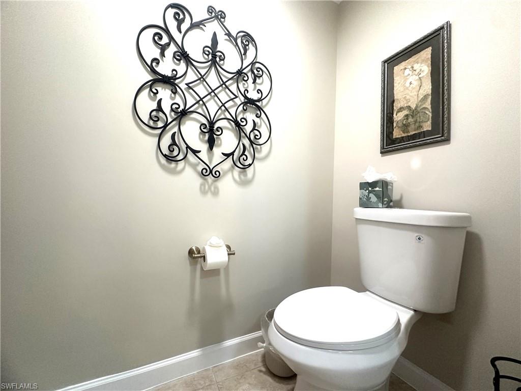 325 Dunes Boulevard, Unit 306 Naples, FL 34110 - Photo 25 of 40 a white toilet sitting next to a bathroom sink
