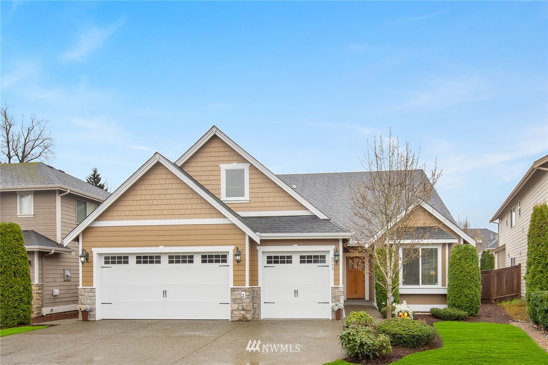 6753 Southeast 2nd Street Renton, WA 98059 - Photo 1 of 32 a view of a white house next to a yard with potted plants