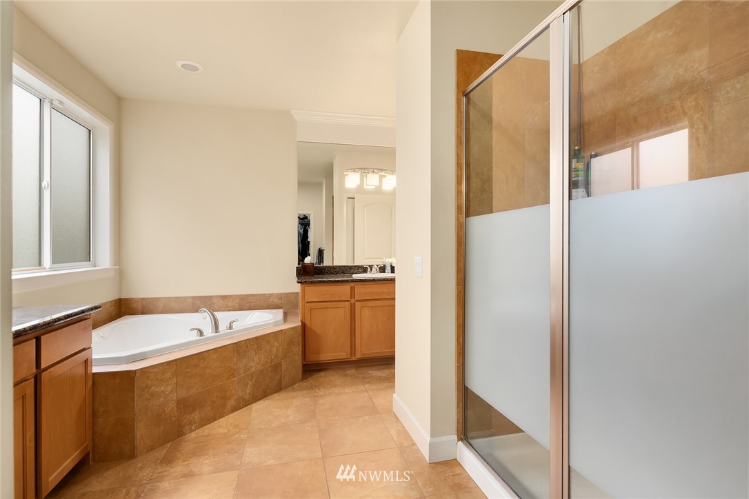 6753 Southeast 2nd Street Renton, WA 98059 - Photo 13 of 32 a bathroom with a tub a sink and a mirror
