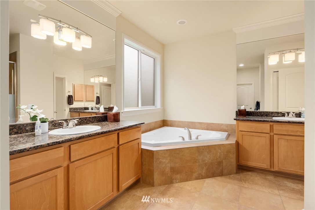 6753 Southeast 2nd Street Renton, WA 98059 - Photo 14 of 32 a bathroom with a tub a sink double vanity and a mirror