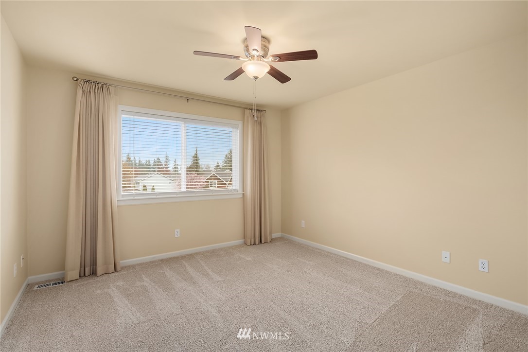 6753 Southeast 2nd Street Renton, WA 98059 - Photo 18 of 32 an empty room with windows and fan