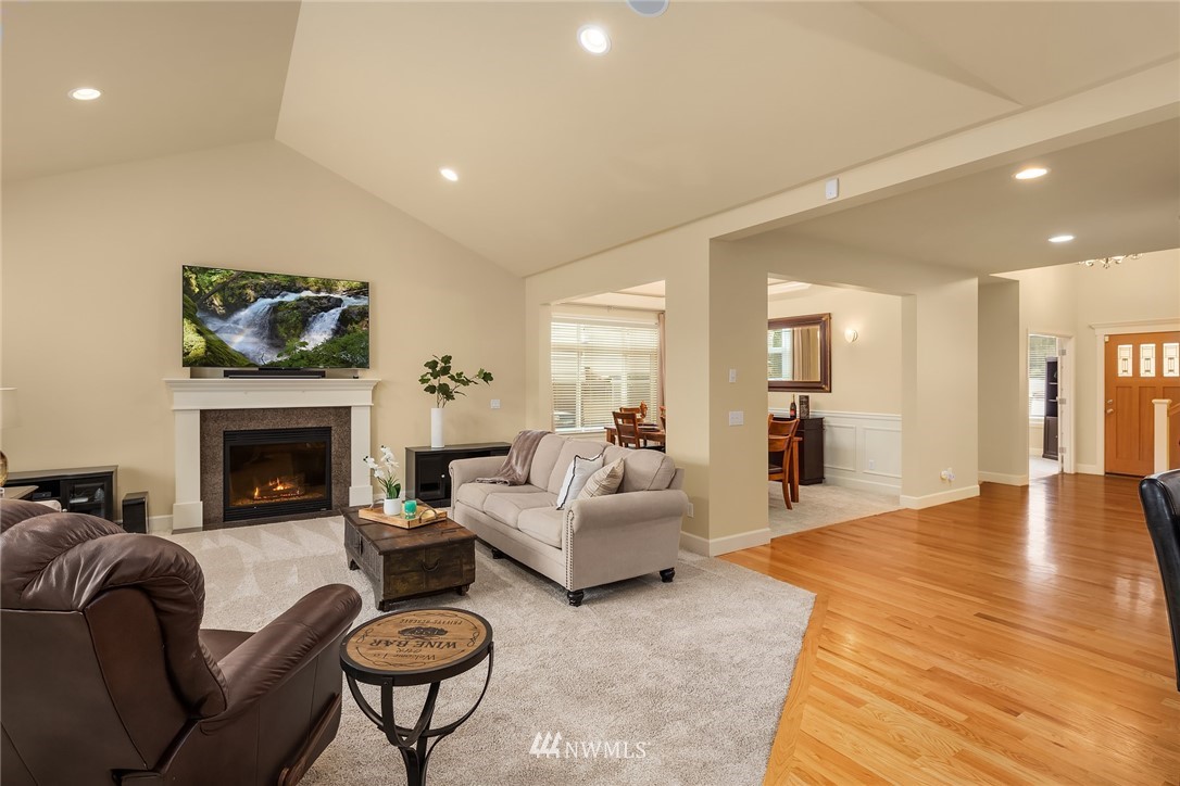 6753 Southeast 2nd Street Renton, WA 98059 - Photo 3 of 32 a living room with furniture a fireplace and a flat screen tv