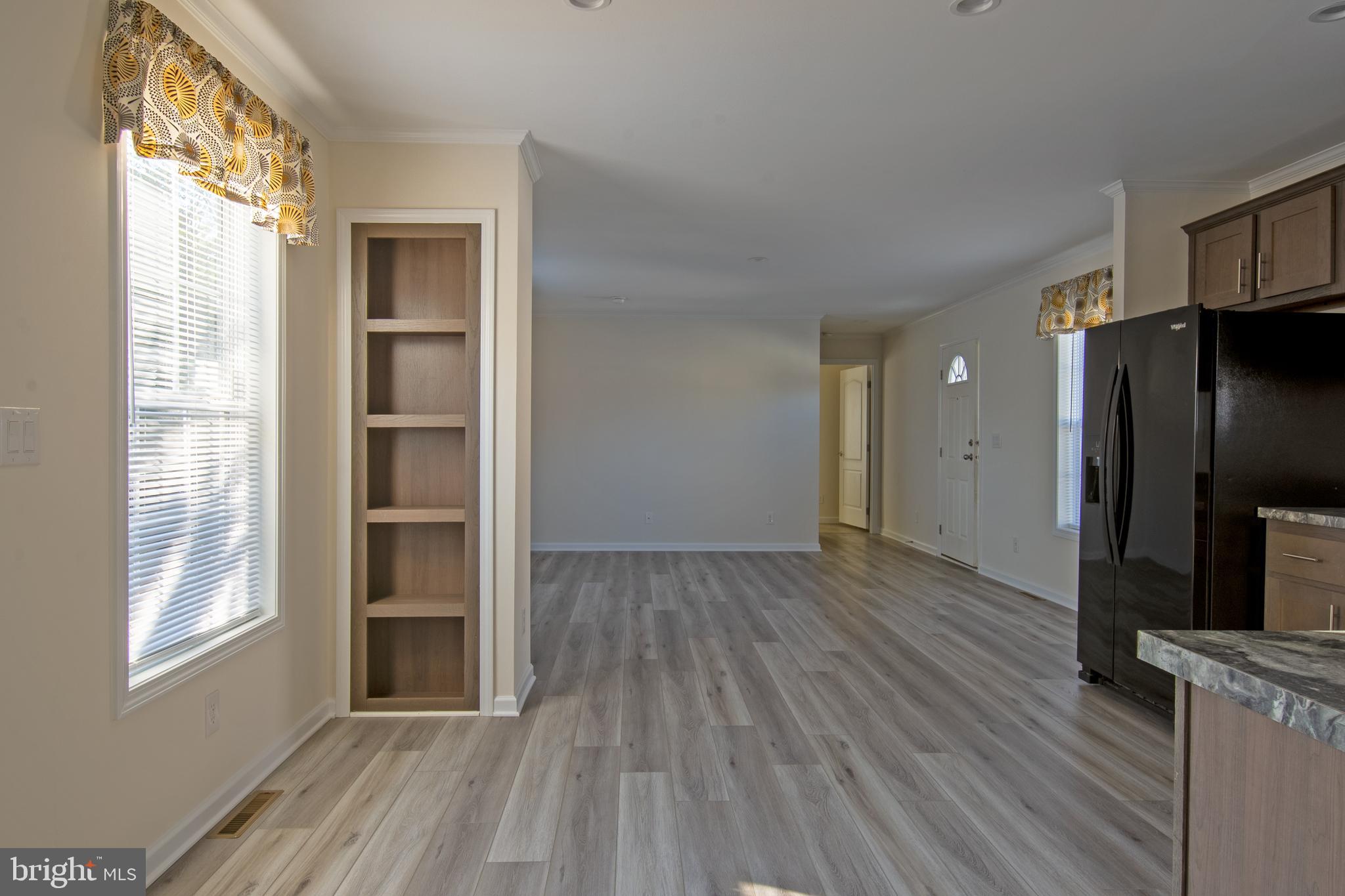 86 Longbow Lane, Unit 86 Hartly, DE 19953 - Photo 17 of 17 a view of empty room with wooden floor and fan