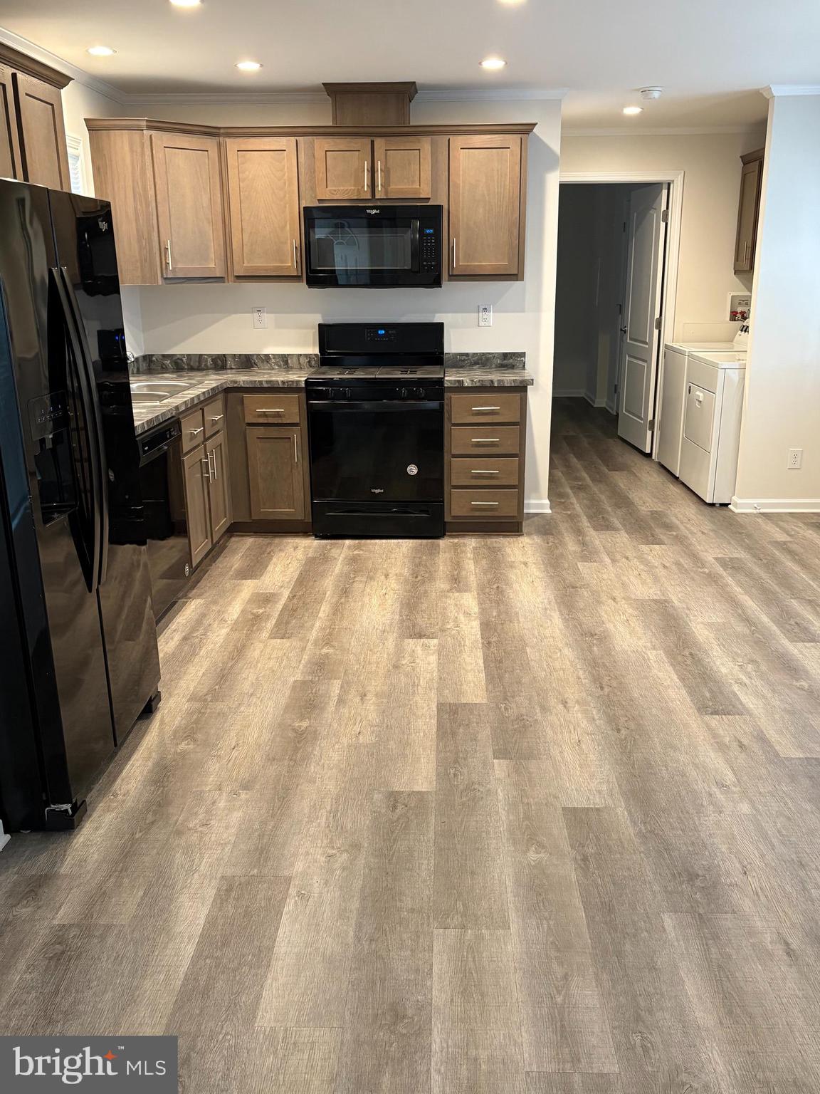 86 Longbow Lane, Unit 86 Hartly, DE 19953 - Photo 3 of 17 a large kitchen with a stove a refrigerator and a sink