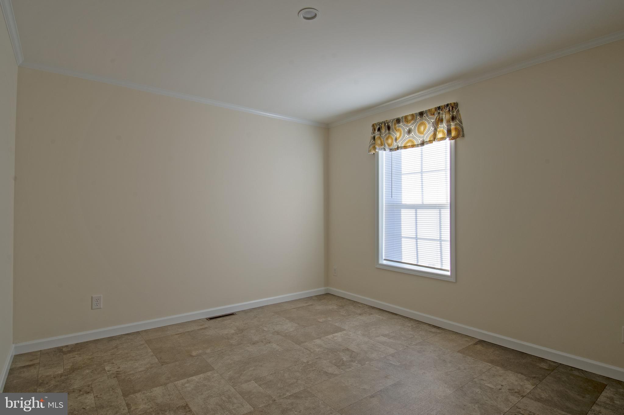 86 Longbow Lane, Unit 86 Hartly, DE 19953 - Photo 5 of 17 an empty room with windows