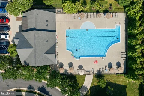 an aerial view of a house with a yard and pool