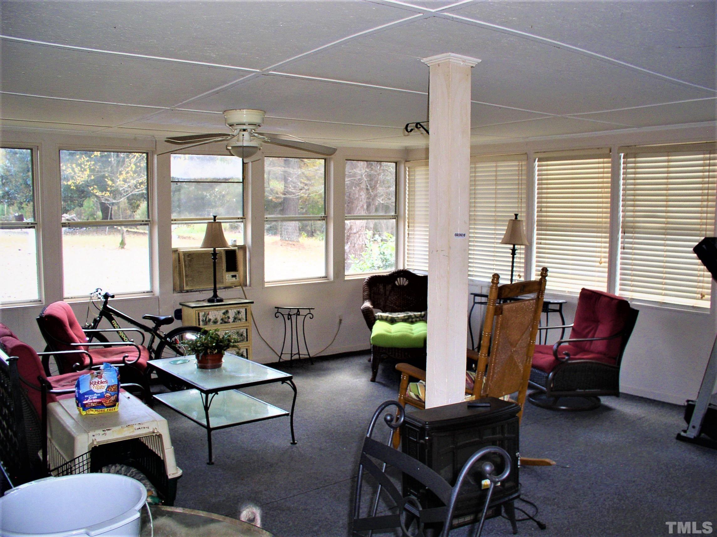 1675 Spring Valley Lake Road Henderson, NC 27537 - Photo 22 of 29 a living room with furniture and floor to ceiling windows