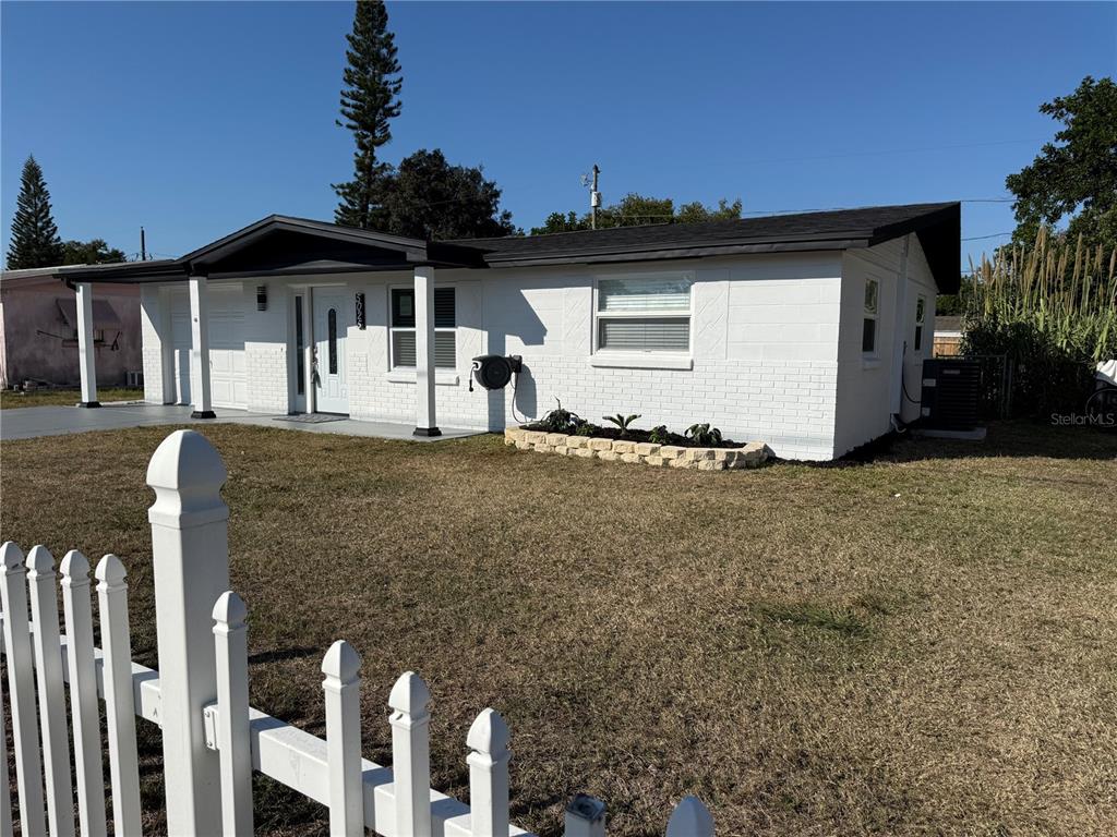 5025 Highway 54 New Port Richey, FL 34652 - Photo 2 of 39 a front view of a house with a yard