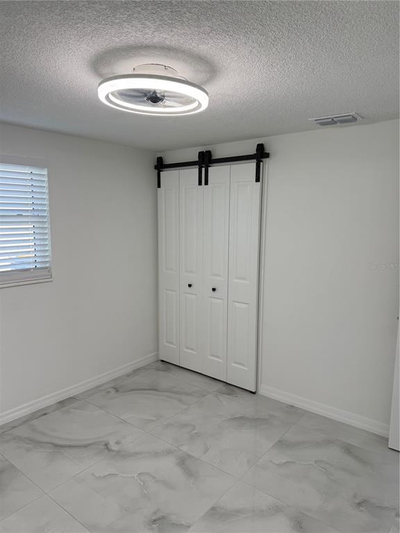 5025 Highway 54 New Port Richey, FL 34652 - Photo 35 of 39 a view of room with a ceiling fan