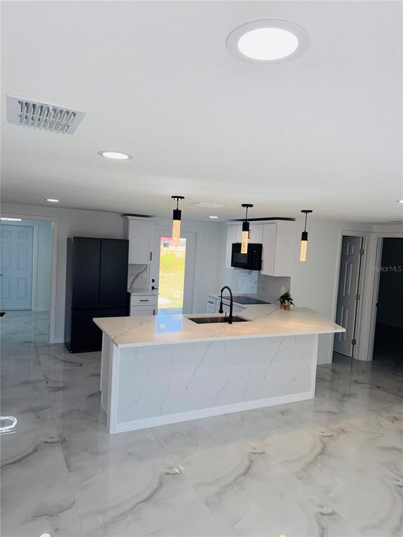 5025 Highway 54 New Port Richey, FL 34652 - Photo 8 of 39 a kitchen with a sink and breakfast area