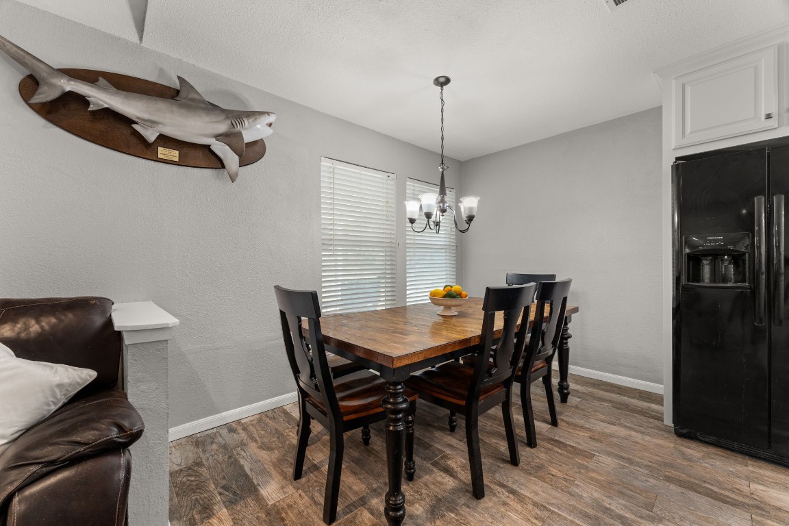 24906 Fawn Drive Leander, TX 78641 - Photo 12 of 39 a view of a dining room with furniture wooden floor and chandelier