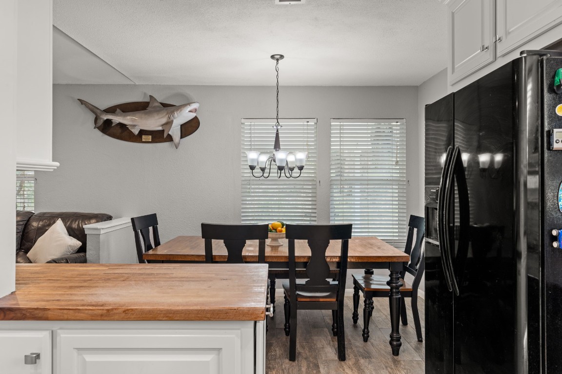 24906 Fawn Drive Leander, TX 78641 - Photo 16 of 39 a view of a dining room with furniture window and wooden floor