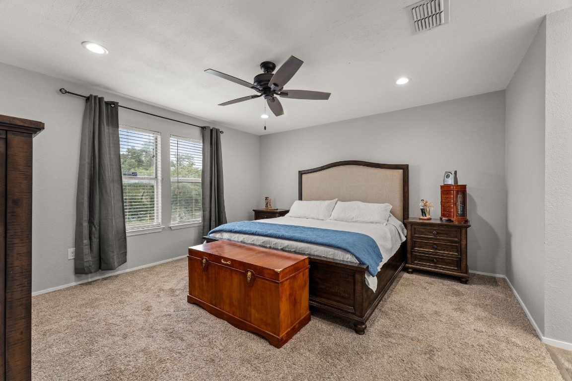 24906 Fawn Drive Leander, TX 78641 - Photo 17 of 39 a spacious bedroom with a bed and window