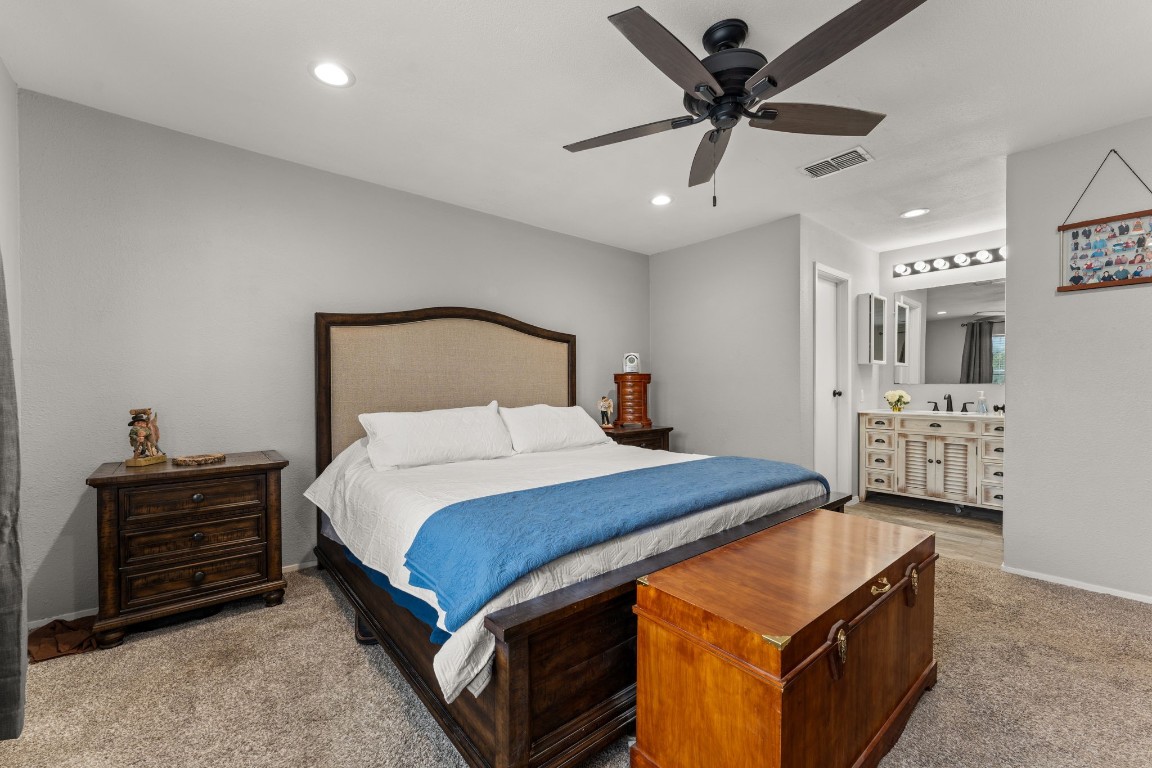 24906 Fawn Drive Leander, TX 78641 - Photo 18 of 39 a bedroom with a bed and a chandelier
