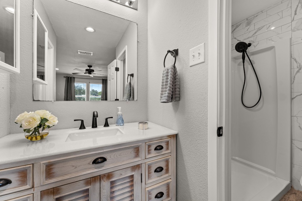 24906 Fawn Drive Leander, TX 78641 - Photo 19 of 39 a bathroom with a sink and a mirror