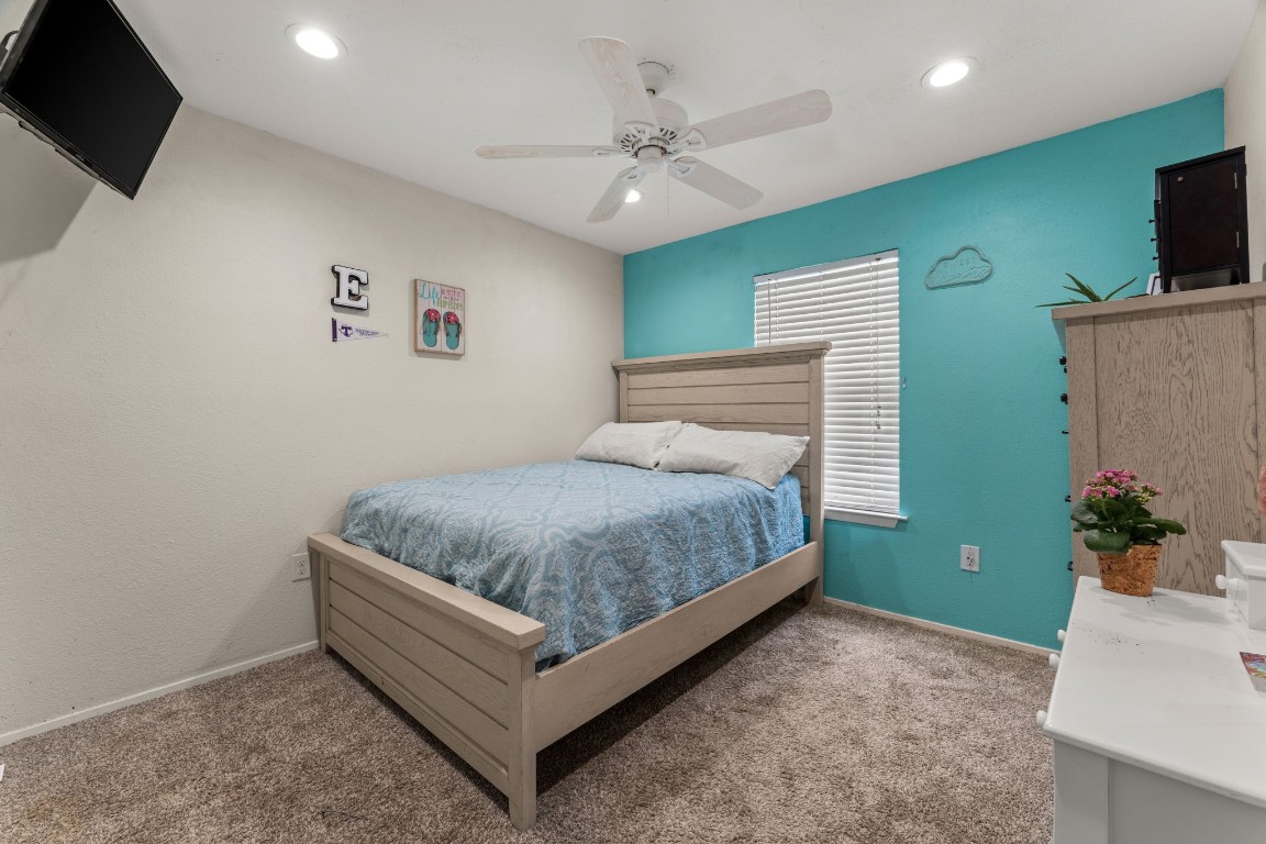 24906 Fawn Drive Leander, TX 78641 - Photo 21 of 39 a bedroom with a bed and a flat screen tv