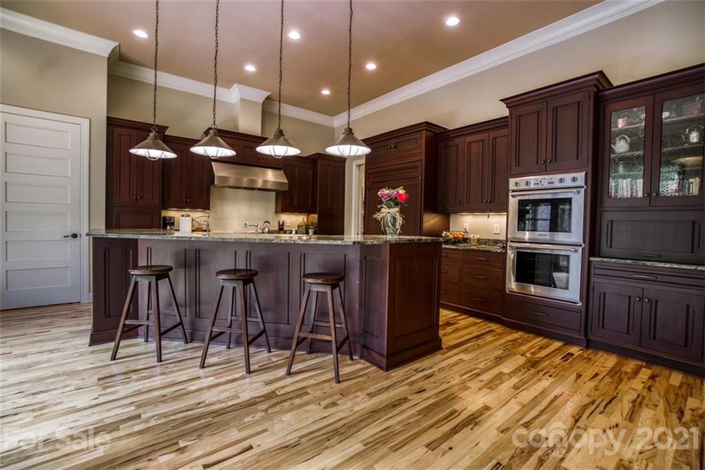 9658 Van Wyck Road Lancaster, SC 29720 - Photo 11 of 44 a kitchen with stainless steel appliances kitchen island granite countertop a stove a sink and a microwave