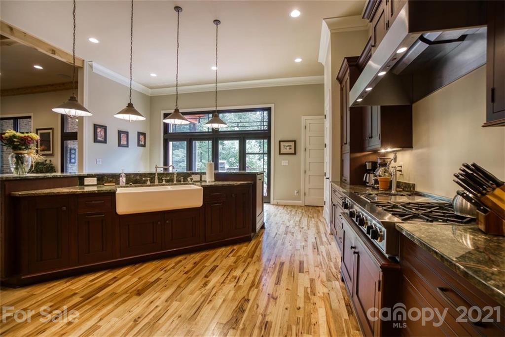 9658 Van Wyck Road Lancaster, SC 29720 - Photo 13 of 44 a large kitchen with stainless steel appliances granite countertop a stove and a wooden floors