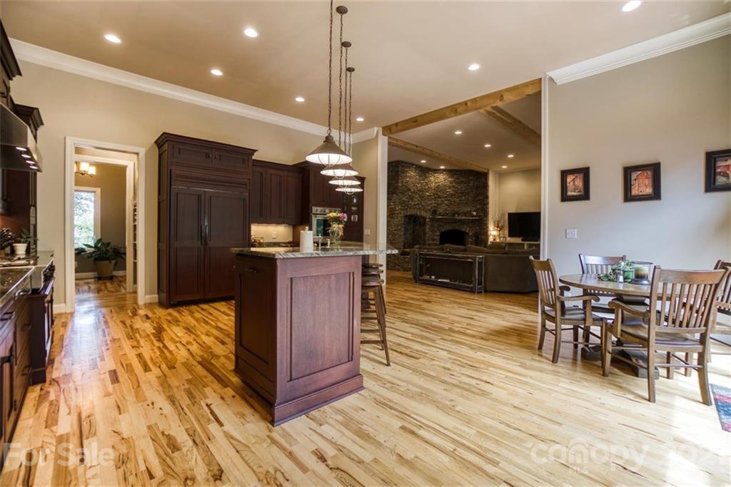 9658 Van Wyck Road Lancaster, SC 29720 - Photo 16 of 44 a living room with stainless steel appliances kitchen island granite countertop a couch a dining table and chairs with wooden floor