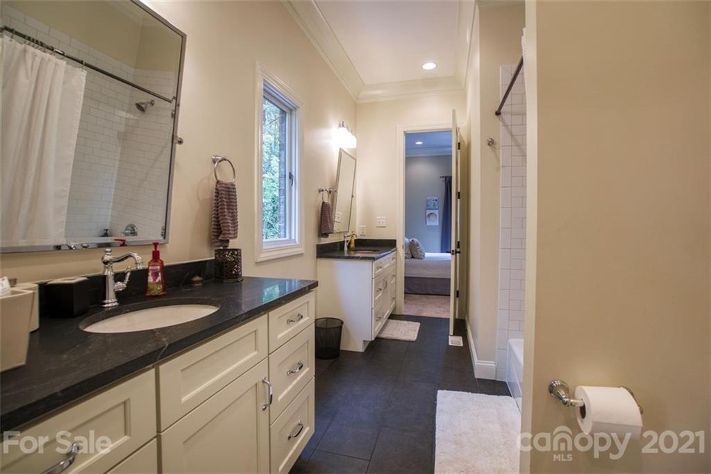 9658 Van Wyck Road Lancaster, SC 29720 - Photo 29 of 44 a bathroom with a double vanity sink a mirror and a shower
