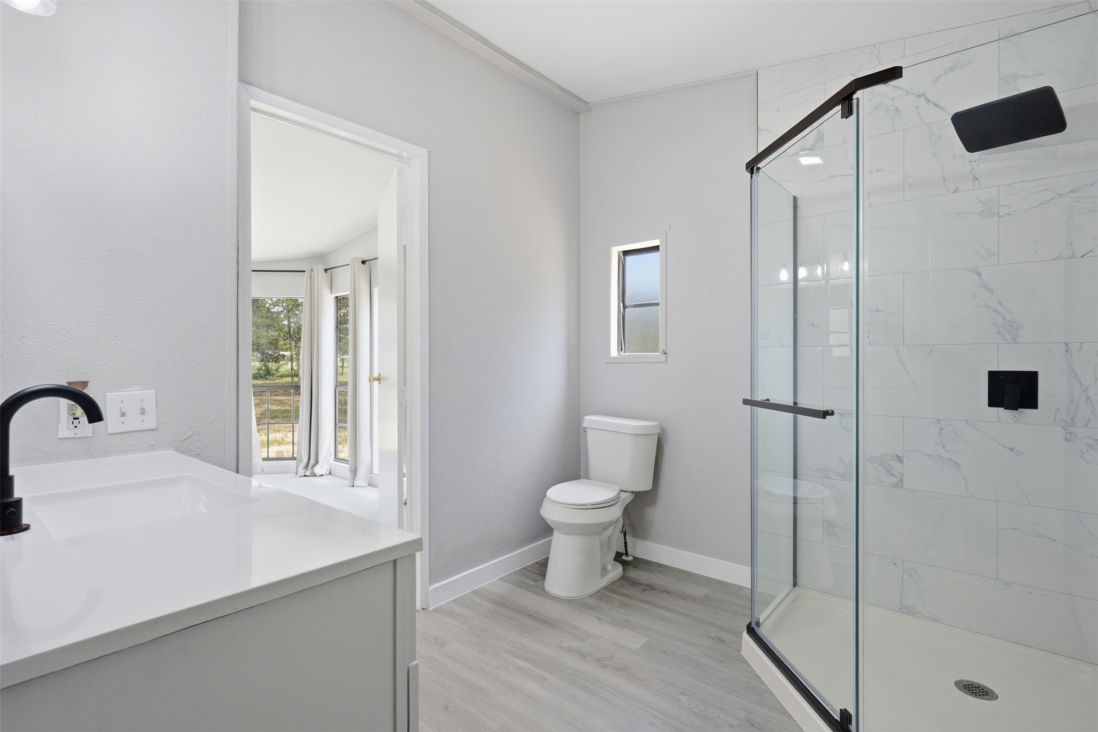 154 Antioch Road Smithville, TX 78957 - Photo 17 of 32 A well-appointed bathroom with a spacious glass-enclosed shower and a modern vanity.
