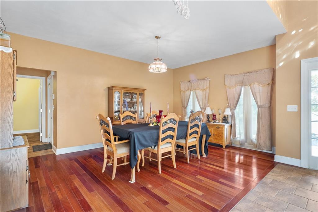 292 Myoma Road Mars, PA 16046 - Photo 20 of 50 a dining room with wooden floor a chandelier a glass table and chairs