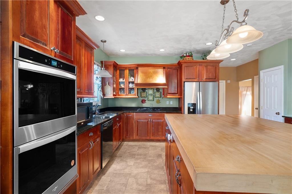 292 Myoma Road Mars, PA 16046 - Photo 25 of 50 a large kitchen with stainless steel appliances kitchen island granite countertop a sink and cabinets