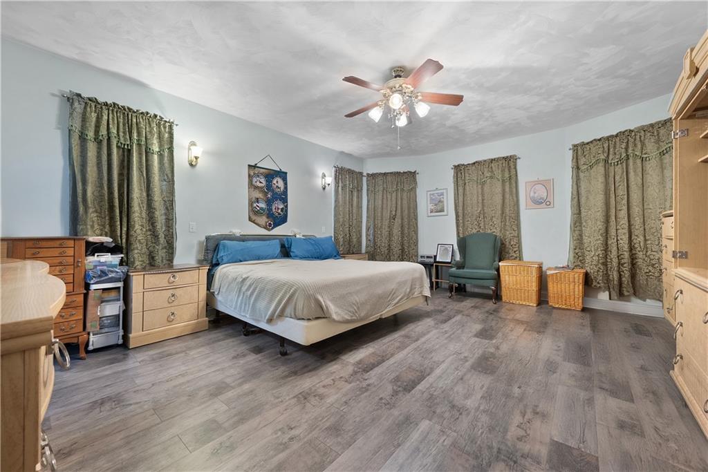 292 Myoma Road Mars, PA 16046 - Photo 28 of 50 a spacious bedroom with a large bed and a chandelier