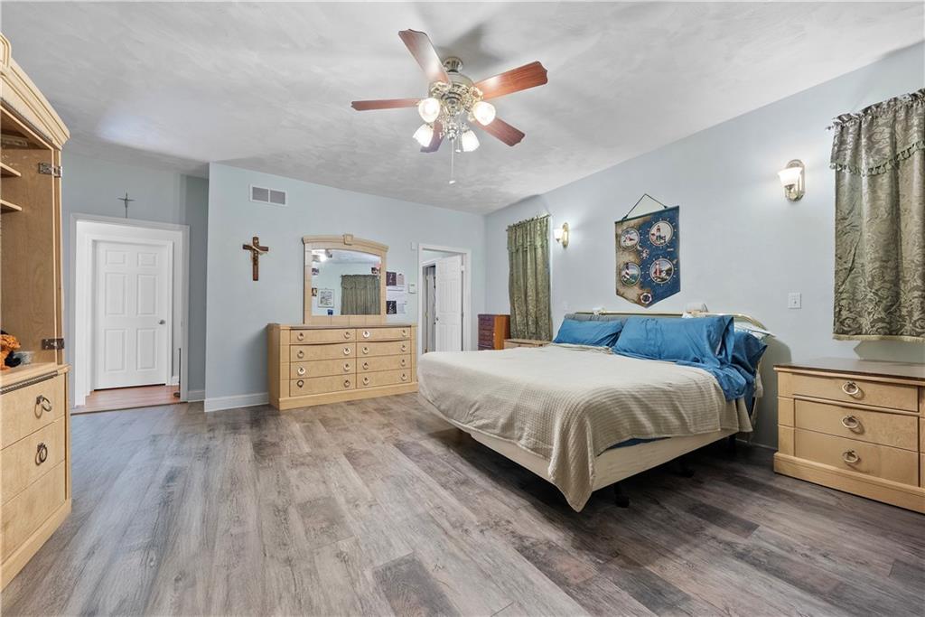 292 Myoma Road Mars, PA 16046 - Photo 29 of 50 a spacious bedroom with a bed and a chandelier