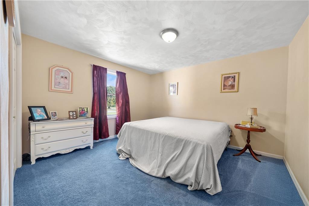 292 Myoma Road Mars, PA 16046 - Photo 37 of 50 a spacious bedroom with a bed and a table