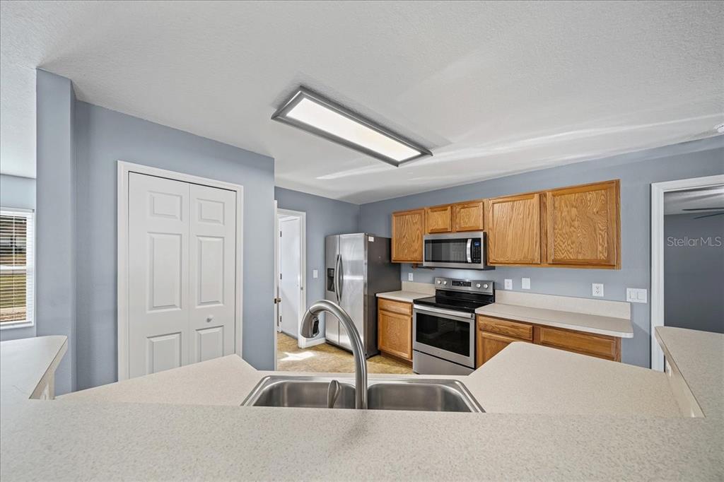 155 Juniper Way Ocala, FL 34480 - Photo 12 of 67 a kitchen with granite countertop a stove a sink and a refrigerator