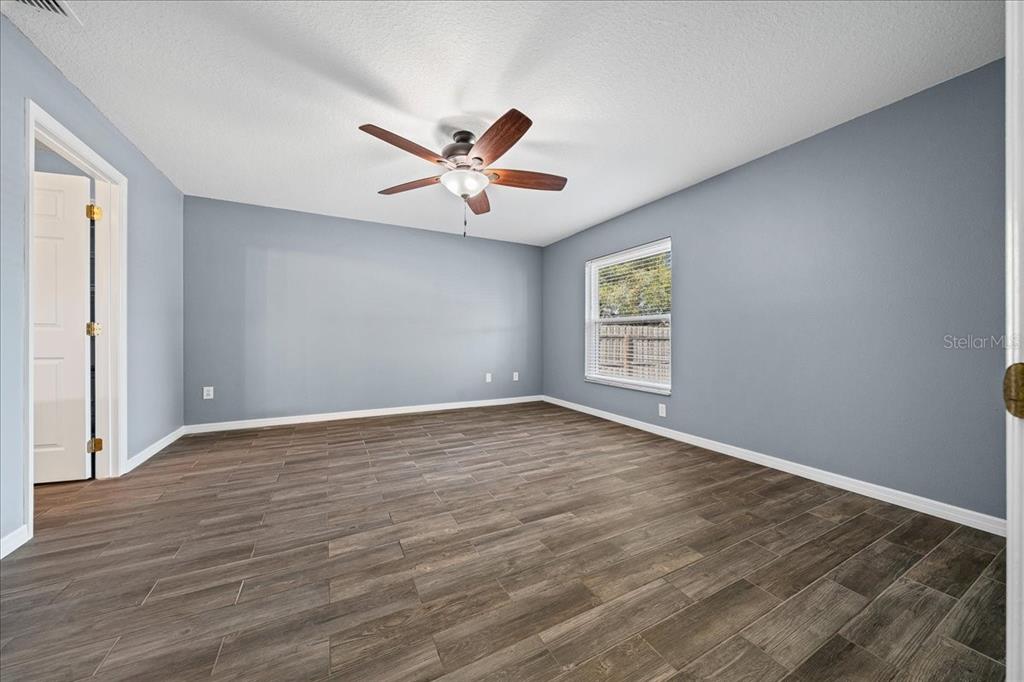 155 Juniper Way Ocala, FL 34480 - Photo 15 of 67 a view of an empty room with window and wooden floor