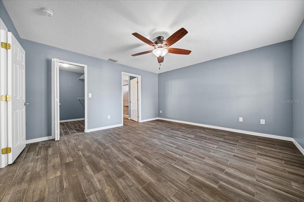 155 Juniper Way Ocala, FL 34480 - Photo 16 of 67 wooden floor in an empty room with a window