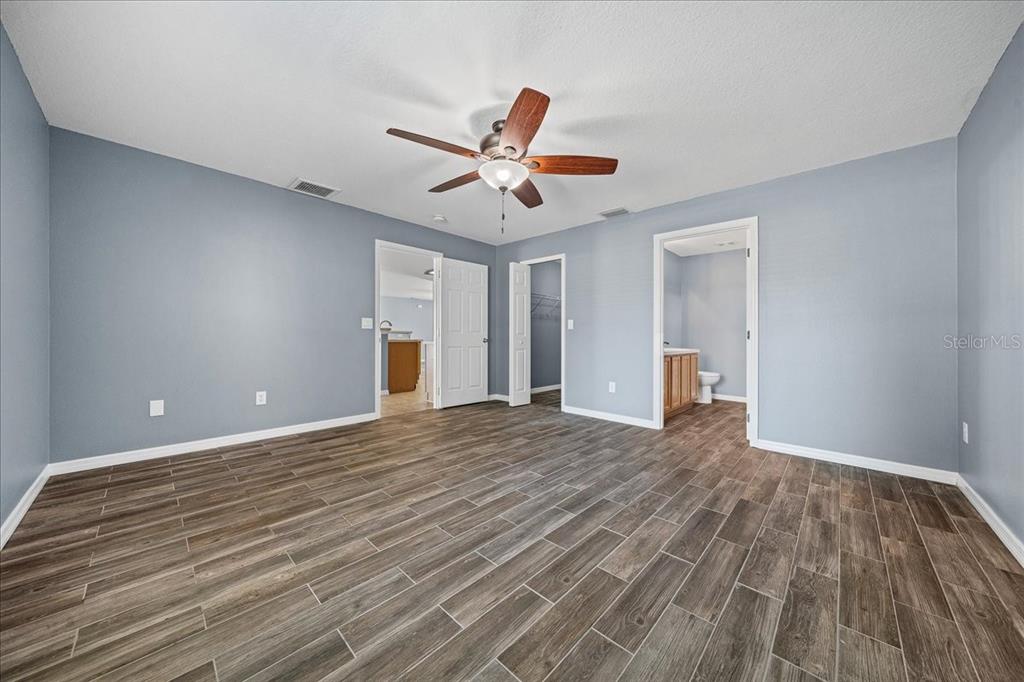 155 Juniper Way Ocala, FL 34480 - Photo 17 of 67 a view of empty room with wooden floor and ceiling fan