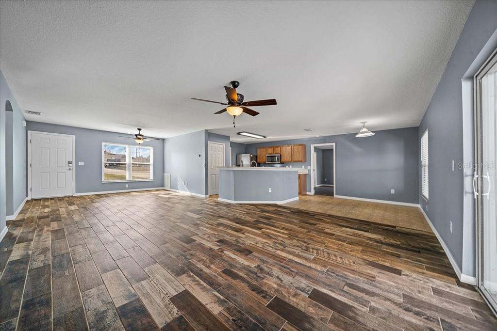 155 Juniper Way Ocala, FL 34480 - Photo 4 of 67 a view of empty room with wooden floor and window