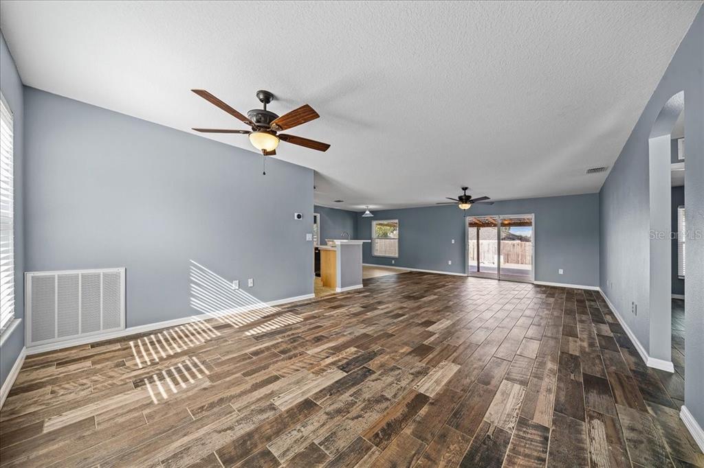 155 Juniper Way Ocala, FL 34480 - Photo 5 of 67 a view of a livingroom with a hardwood floor and a ceiling fan