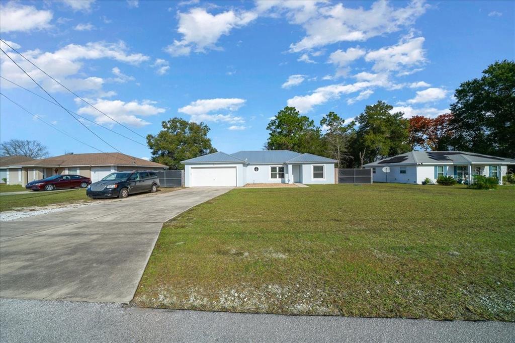 155 Juniper Way Ocala, FL 34480 - Photo 54 of 67 a front view of a house with garden