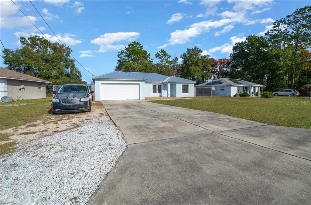 155 Juniper Way Ocala, FL 34480 - Photo 55 of 67 a front view of a house with a garden and yard