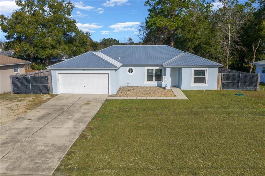 155 Juniper Way Ocala, FL 34480 - Photo 58 of 67 a front view of a house with yard and green space