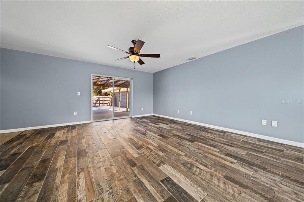 155 Juniper Way Ocala, FL 34480 - Photo 7 of 67 a view of empty room with wooden floor and fan